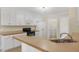 Well-lit kitchen features white appliances, eat-in breakfast bar, and easy access to the laundry room at 198 Hillsdale Dr, Archer Lodge, NC 27527