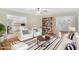 Comfortable living area with chairs, bookshelf, and modern decor that opens to the front entry and kitchen at 198 Hillsdale Dr, Archer Lodge, NC 27527
