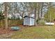 Backyard shed with gray wood siding, and mature trees at 198 Hillsdale Dr, Archer Lodge, NC 27527