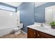 Clean bathroom with updated vanity, tub, and a toilet with decorative plant at 2 Bolter Ct, Durham, NC 27704