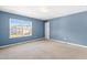 Comfortable bedroom featuring neutral carpeting and a window view at 2 Bolter Ct, Durham, NC 27704