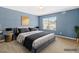 Calming primary bedroom with a blue accent wall, king bed, and side tables at 2 Bolter Ct, Durham, NC 27704