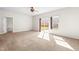 Living space with neutral carpet, a ceiling fan, and sliding doors leading to the backyard at 2 Bolter Ct, Durham, NC 27704