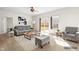 Bright living room with neutral decor, featuring a gray sofa, chair, and access to a patio at 2 Bolter Ct, Durham, NC 27704