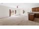 Open living and kitchen area features neutral carpet, access to a patio, and space for customization at 2 Bolter Ct, Durham, NC 27704