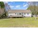 Back of house featuring a deck, windows, and well maintained lawn at 201 Alice Dr, Garner, NC 27529