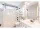 Bright bathroom with white vanity, shower and tub, featuring a cabinet with baskets at 201 Alice Dr, Garner, NC 27529