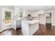 Updated kitchen with white cabinets, stainless appliances, center island, and door to backyard at 201 Alice Dr, Garner, NC 27529