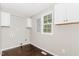 Well-lit laundry room with white cabinets and a window for natural light at 201 Alice Dr, Garner, NC 27529