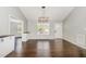 Open-concept living area with hardwood floors, natural light, and built-in cabinets at 201 Alice Dr, Garner, NC 27529