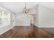 Spacious living room with hardwood floors, vaulted ceiling, and modern light fixture at 201 Alice Dr, Garner, NC 27529