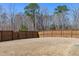 Expansive backyard with a wood fence and grass, offering ample outdoor space for recreation and relaxation at 2040 Water Marsh Trl, Fuquay Varina, NC 27526