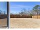 View of backyard with tall privacy fence and dry grass at 2040 Water Marsh Trl, Fuquay Varina, NC 27526