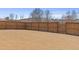 Large fenced backyard with dry grass and trees at 2040 Water Marsh Trl, Fuquay Varina, NC 27526