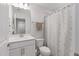 Neat bathroom featuring a single vanity, white countertop, toilet, and shower with patterned curtain at 2040 Water Marsh Trl, Fuquay Varina, NC 27526