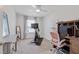 Inviting bedroom with ceiling fan, exercise bike, desk, and neutral decor, creating a versatile space at 2040 Water Marsh Trl, Fuquay Varina, NC 27526