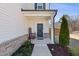 Inviting front porch with charming decor, a welcome sign, and a brick facade at 2040 Water Marsh Trl, Fuquay Varina, NC 27526