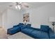 Inviting living room featuring blue sofas and a wooden coffee table, brightened by natural light and décor at 2040 Water Marsh Trl, Fuquay Varina, NC 27526