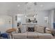 Open living space with a couch, adjacent kitchen, and a view of the dining area at 2040 Water Marsh Trl, Fuquay Varina, NC 27526