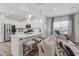 Bright, open-concept living space with kitchen access and a comfortable couch at 2040 Water Marsh Trl, Fuquay Varina, NC 27526