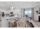 Spacious kitchen with island seating connected to a brightly lit living area at 2040 Water Marsh Trl, Fuquay Varina, NC 27526