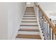 Staircase featuring brown treads and decorative wrought iron spindles at 2040 Water Marsh Trl, Fuquay Varina, NC 27526