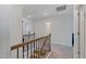 Upstairs hallway with carpet, decorative railing, and access to bedrooms at 2040 Water Marsh Trl, Fuquay Varina, NC 27526