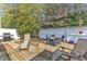 A fully-fenced backyard with mature landscaping, patio, and barbecue grill at 2043 White Pond Ct, Apex, NC 27523