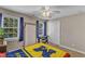 This bedroom includes neutral walls, two windows with white trim, and a ceiling fan at 2043 White Pond Ct, Apex, NC 27523