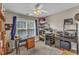 Neutral-toned craft room featuring large window, ceiling fan, and dual workstations at 2043 White Pond Ct, Apex, NC 27523