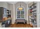 Sunlit dining area with large arched window, custom cabinet, and hardwood floors providing an inviting space to dine at 2043 White Pond Ct, Apex, NC 27523