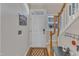 Bright foyer with stairs and coat rack for convenience with a wood floor and white trim at 2043 White Pond Ct, Apex, NC 27523
