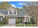 Charming townhome with a brick facade, attached garage, and well-manicured landscaping at 2043 White Pond Ct, Apex, NC 27523