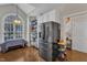 Spacious kitchen featuring black stainless steel refrigerator, custom cabinet, and hardwood floors, ideal for culinary enthusiasts at 2043 White Pond Ct, Apex, NC 27523