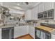 Cozy kitchen featuring white cabinets, modern appliances, and an open design, creating a warm and inviting cooking space at 2043 White Pond Ct, Apex, NC 27523