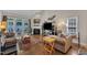 Comfortable living room with a fireplace, hardwood floors, and access to a patio for seamless indoor-outdoor living at 2043 White Pond Ct, Apex, NC 27523