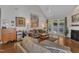 Relaxing living room featuring hardwood floors, modern decor, fireplace, and a walkout to the rear patio at 2043 White Pond Ct, Apex, NC 27523