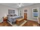 Serene main bedroom featuring hardwood floors, natural light, and calming decor creating a peaceful retreat at 2043 White Pond Ct, Apex, NC 27523