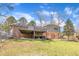View of backyard with a wooden deck and covered patio that offers space for outdoor activities at 215 Longview Dr, Smithfield, NC 27577