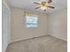 Bedroom with a window and a closet with sliding doors and a ceiling fan at 215 Longview Dr, Smithfield, NC 27577