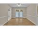 Bright dining room features wood floors, ceiling fan, and glass doors to outside space at 215 Longview Dr, Smithfield, NC 27577