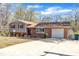 This home has a blend of brick and siding, attached garage and beautiful blue skies above the home at 215 Longview Dr, Smithfield, NC 27577