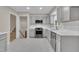 Renovated kitchen with white marble floors, gray cabinets, and stainless appliances at 215 Longview Dr, Smithfield, NC 27577