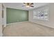 Cozy living room featuring neutral carpet, a ceiling fan, and a large window with natural light at 215 Longview Dr, Smithfield, NC 27577
