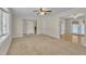 Spacious living room featuring neutral carpet, large window and an open floor plan leading to other rooms at 215 Longview Dr, Smithfield, NC 27577