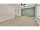 Comfortable living room with neutral carpet, ceiling fan, large window and an open doorway at 215 Longview Dr, Smithfield, NC 27577