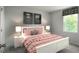 Comfortable bedroom with a decorative bed, coordinating nightstands, and a window for natural lighting at 221 N Coral Bells Way, Four Oaks, NC 27524