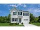 Charming two-story home featuring gray siding, black shutters, and an attached one car garage at 221 N Coral Bells Way, Four Oaks, NC 27524