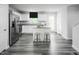 Modern kitchen with white cabinets, stainless steel appliances, and a center island with barstool seating at 221 N Coral Bells Way, Four Oaks, NC 27524