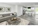 Open-concept living space with a view of the kitchen, featuring modern decor and ample natural light at 221 N Coral Bells Way, Four Oaks, NC 27524